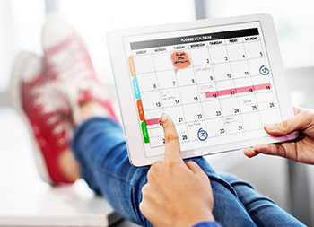 Person looking at personal calendar where Schedule HVAC maintenance is one of the tasks