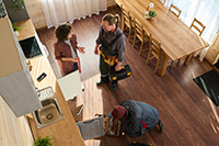 Homeowner speaking with tradespeople about home repairs