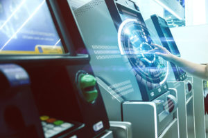 ATM service graphic with white circular halo over the screen of a n ATM being used by an outstretched hand